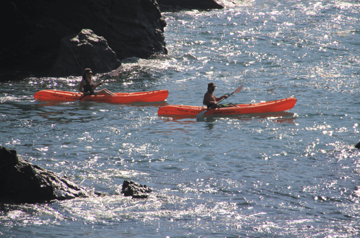 a man and a women kayaking in the sparkly waters of little harbor campground